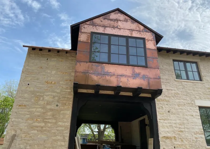 Copper metal panel facade on a stone building for Skylight Installation in Valley