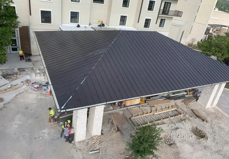 Metal roofing installation team working on a commercial building in Valley